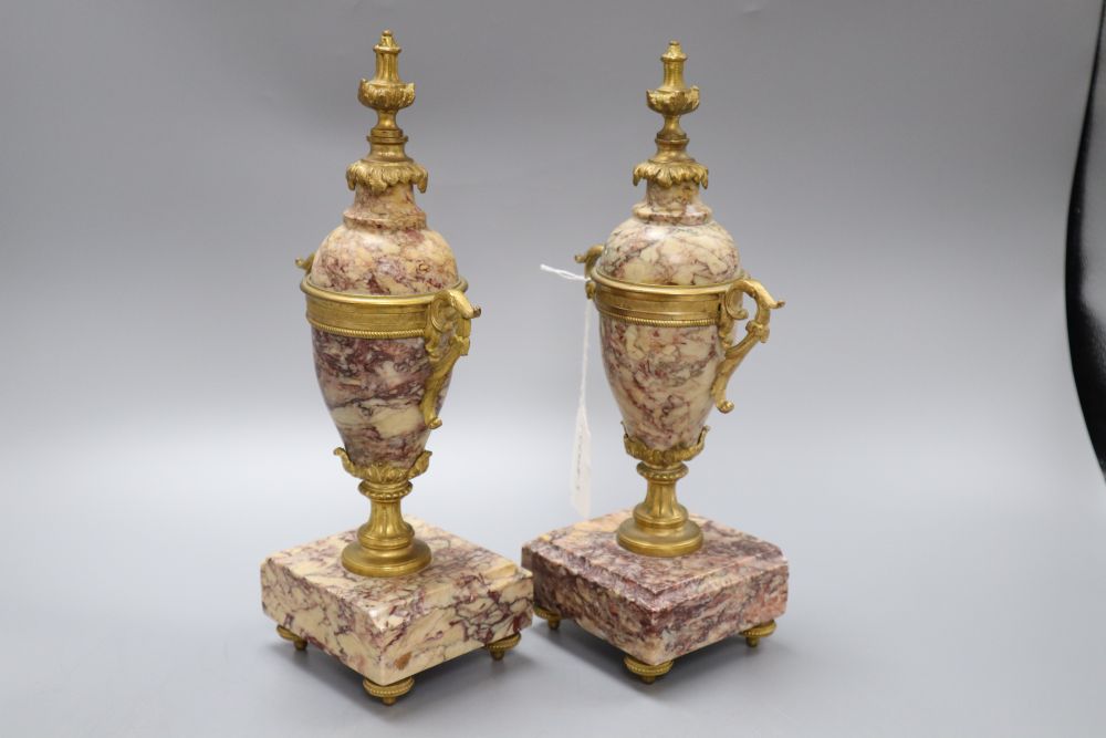 A pair of reconstituted marble and gilt metal urns, height 28.5cm